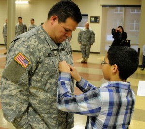 Paul Manzo getting his promotional pin from his son.