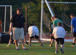 Sachem coach Dave Falco works with younger players in the program.