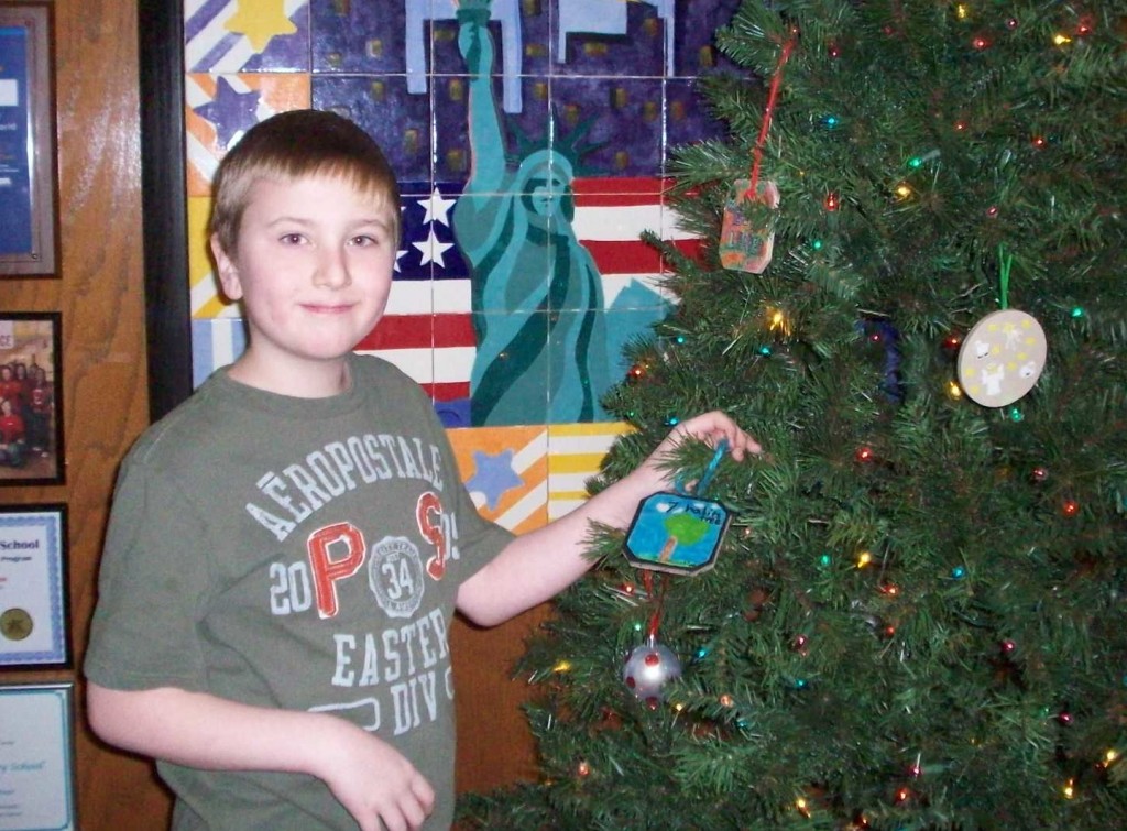 Eammon Sheedy placing his ornament on the 7 Habits Tree.