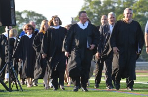 Sachem administrators and school board members walk into graduation.