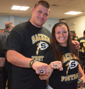Bryan and Danielle Gresalfi hold up their championship rings.