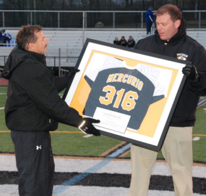 Mercurio (r.) receiving a jersey in honor of his 316 career wins from current Sachem coach and alum Jay Mauro.