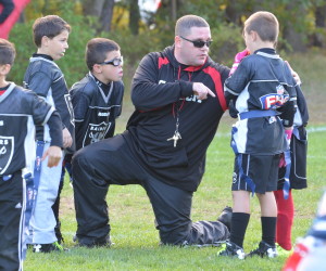 Sachem coach Jimmy Dee giving instruction to Sachem Sports Club flag football players.