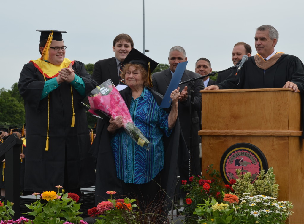 Anita Krausch is honored with a diploma from Sachem.